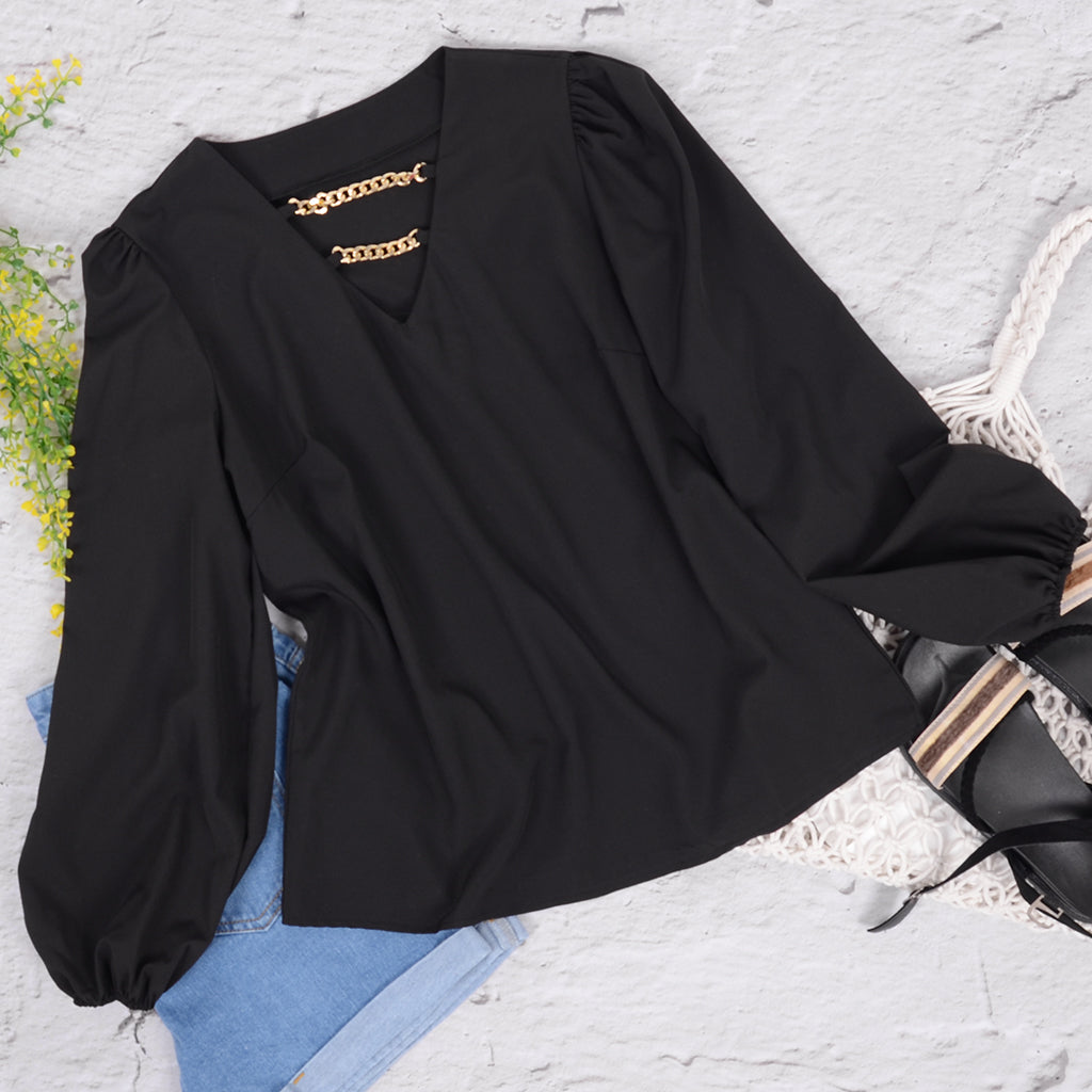 Blusa con mangas abullonadas y cadena