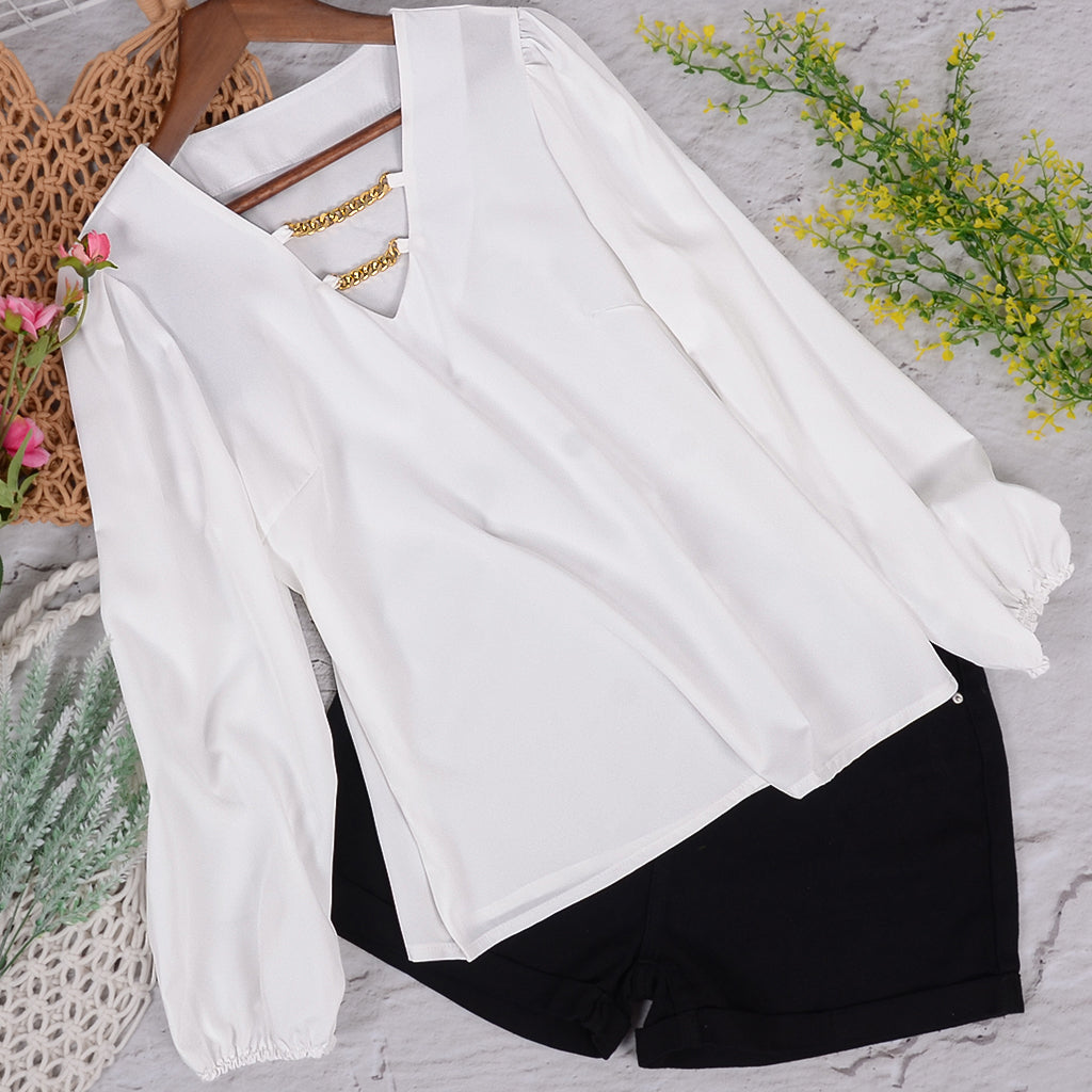 Blusa con mangas abullonadas y cadena