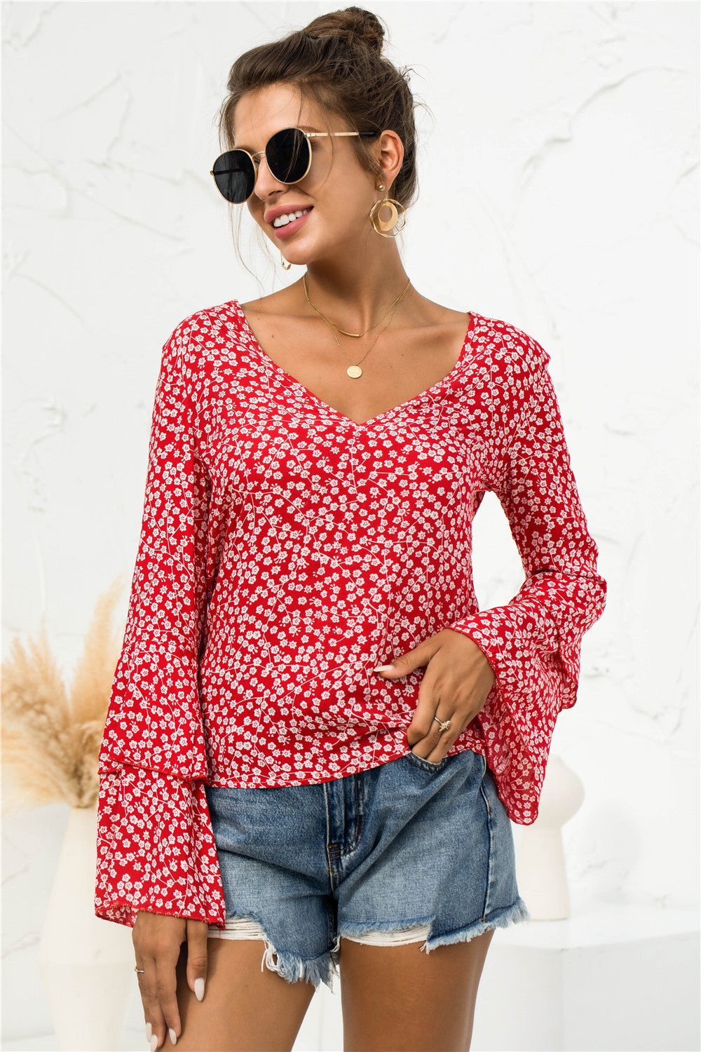 Blusa con escote en V y mangas acampanadas con margaritas suaves