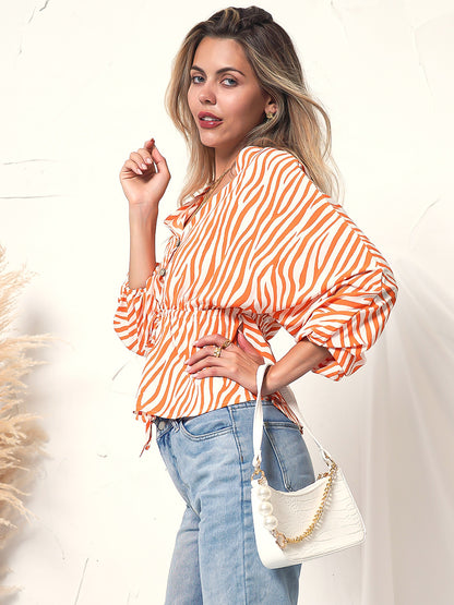 Blusa de manga larga con botones y estampado de cebra 