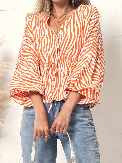 Blusa de manga larga con botones y estampado de cebra 