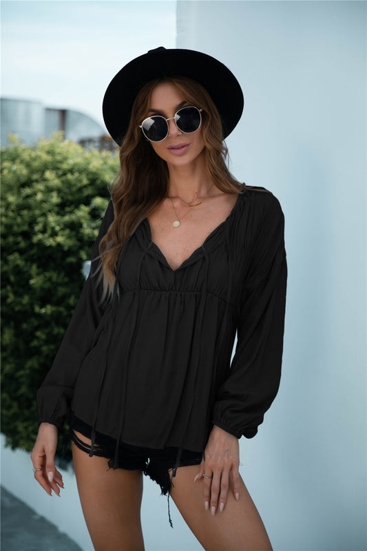 Blusa de manga larga con volantes y cordón anudado