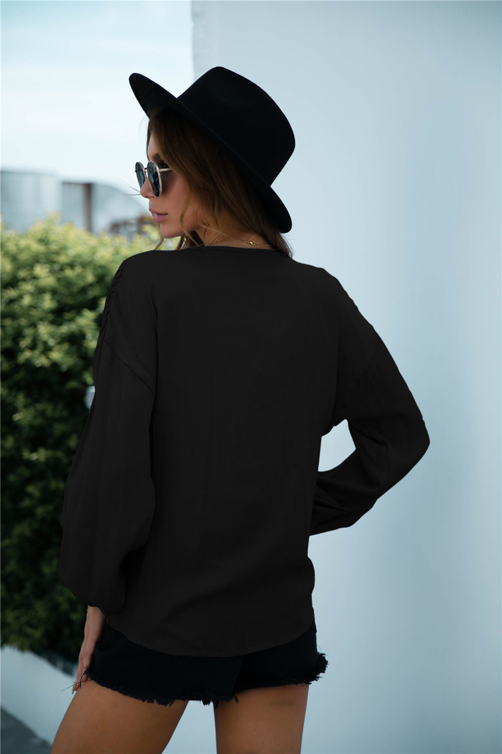 Blusa de manga larga con volantes y cordón anudado