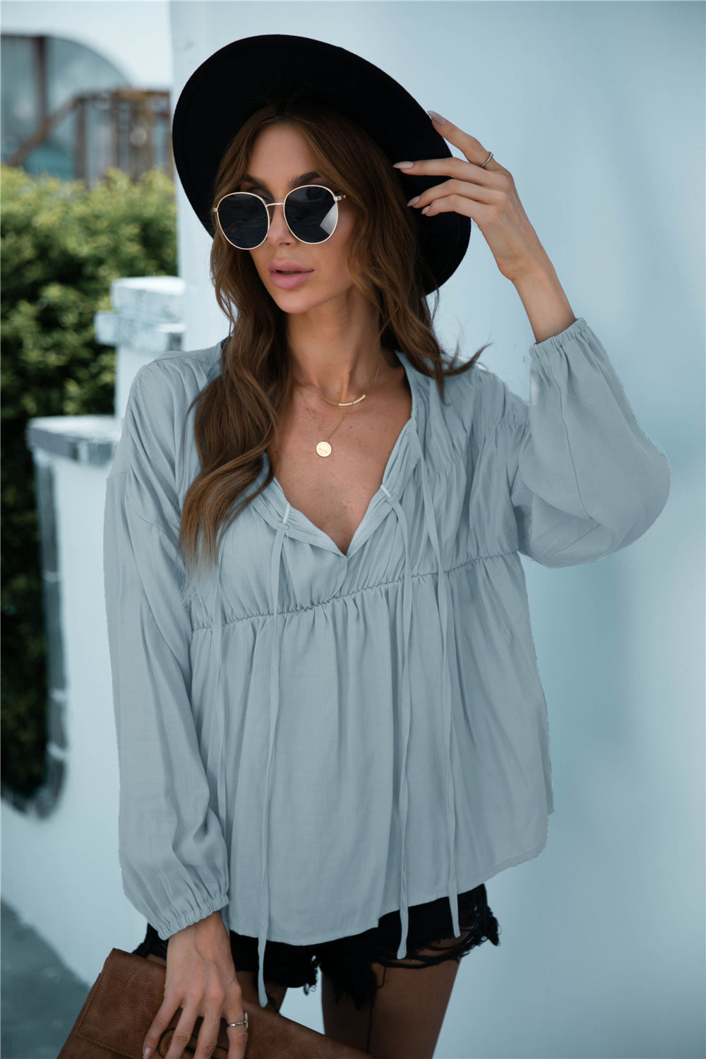 Blusa de manga larga con volantes y cordón anudado