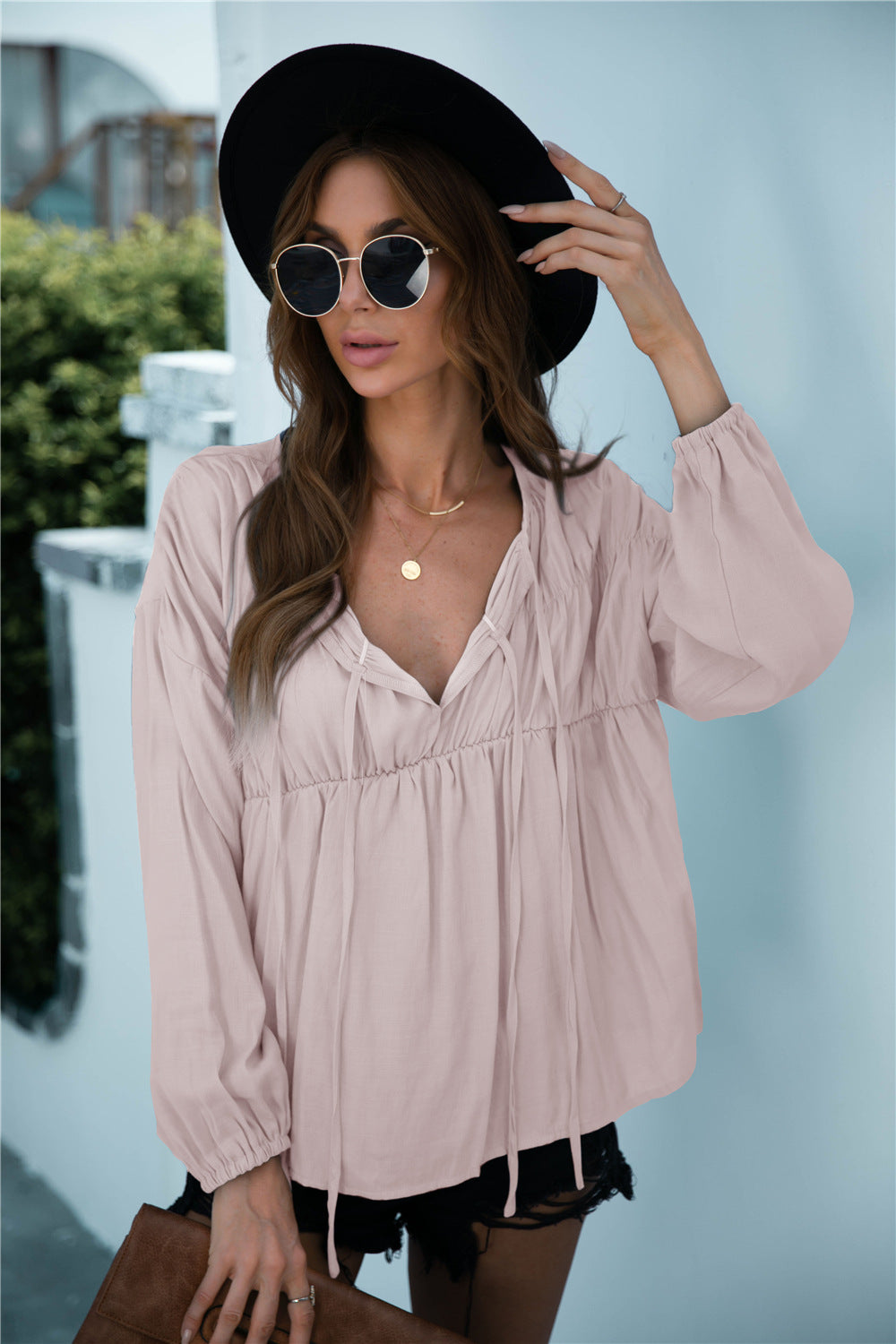 Blusa de manga larga con volantes y cordón anudado