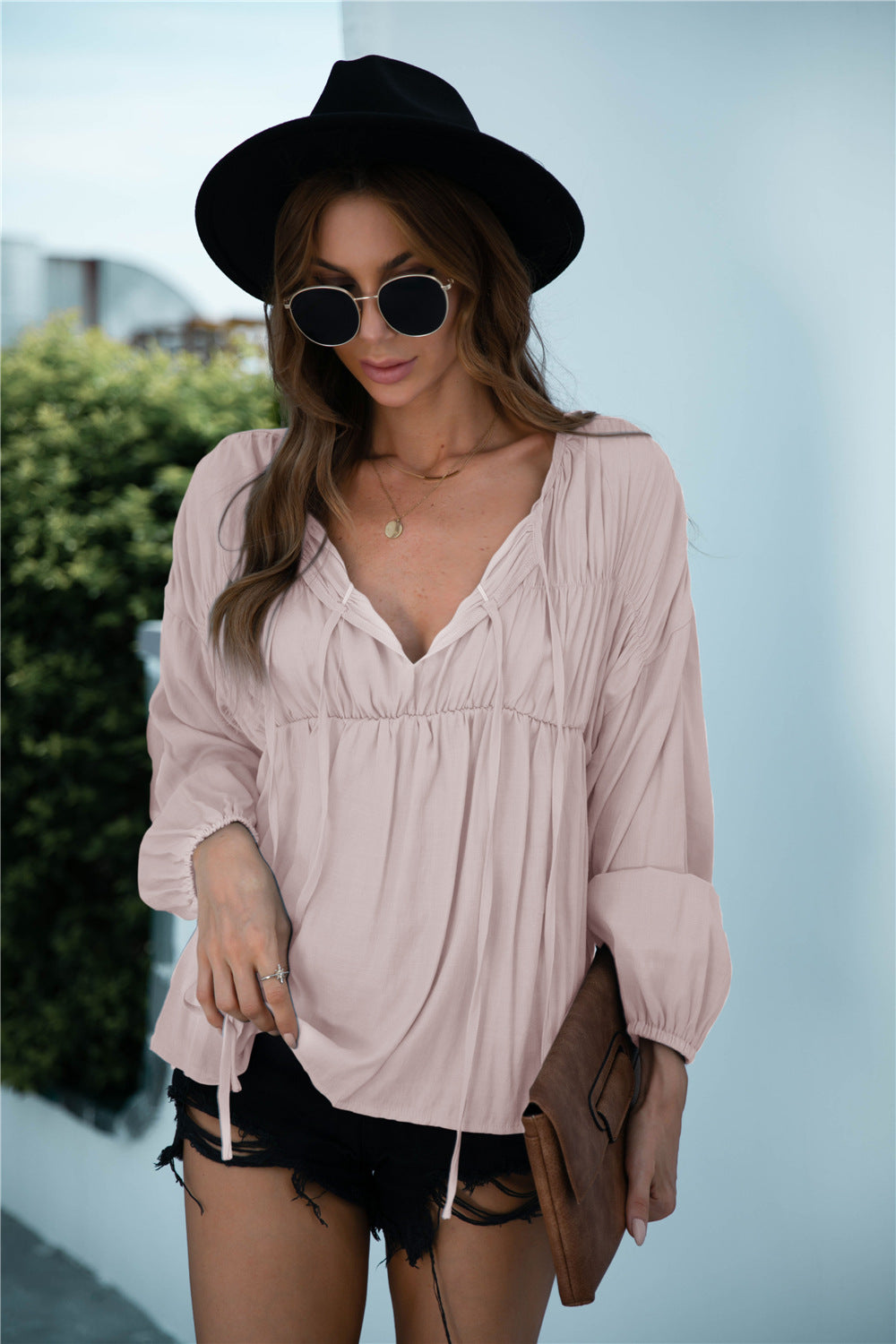 Blusa de manga larga con volantes y cordón anudado
