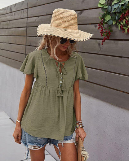 Blusa con mangas sueltas y cuello anudado
