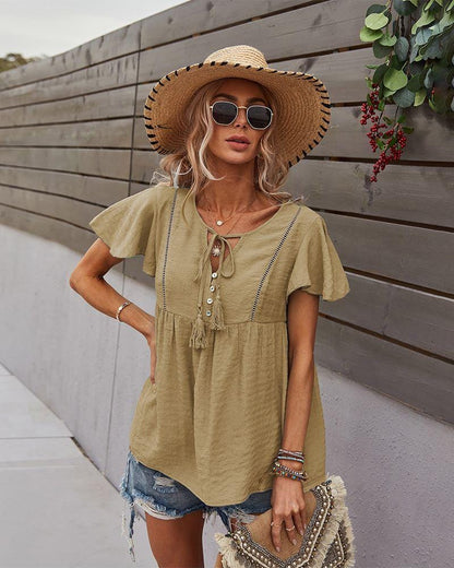 Blusa con mangas sueltas y cuello anudado