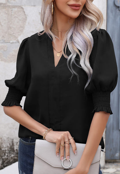Blusa con mangas abullonadas y pliegues en la espalda