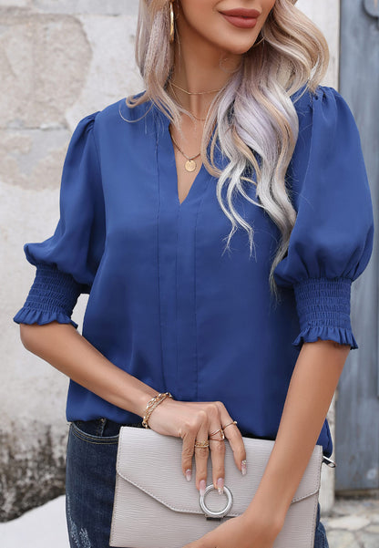 Blusa con mangas abullonadas y pliegues en la espalda