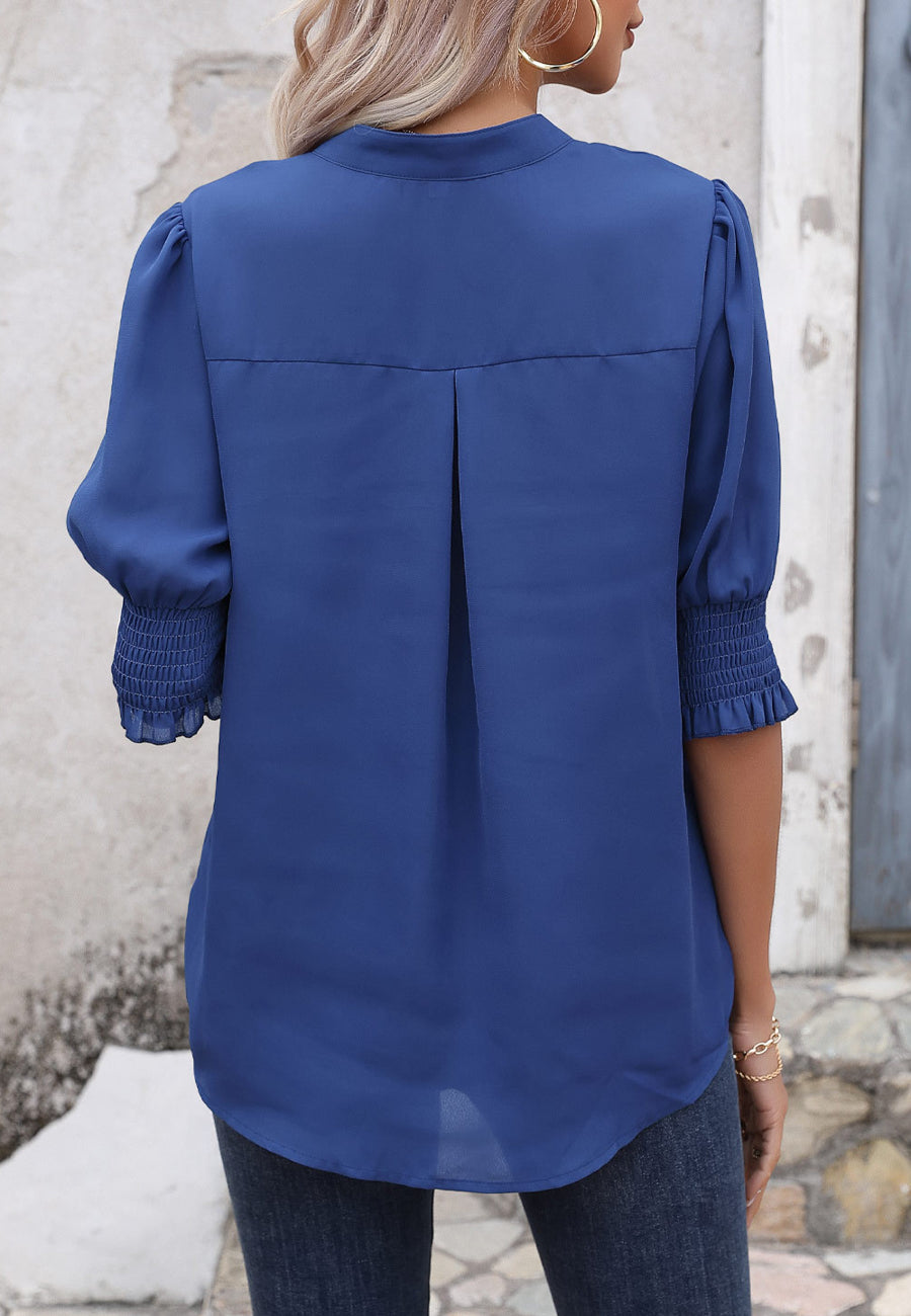 Blusa con mangas abullonadas y pliegues en la espalda