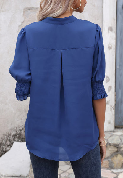 Blusa con mangas abullonadas y pliegues en la espalda