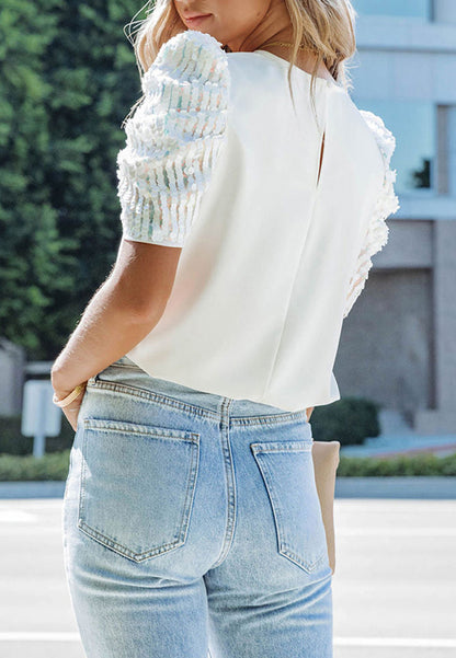 Blusa con mangas abullonadas y lentejuelas