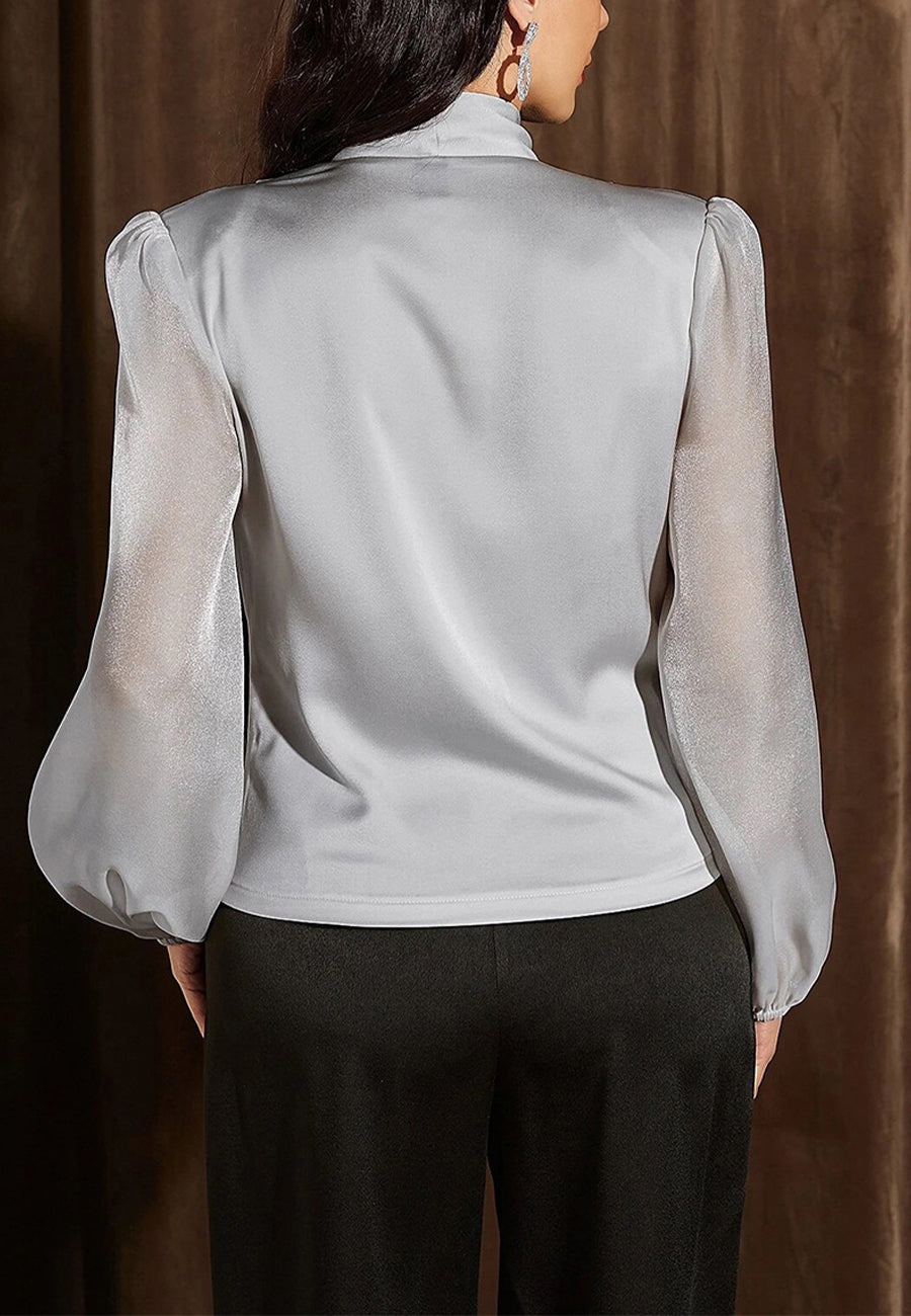 Blusa cruzada con mangas de obispo transparente