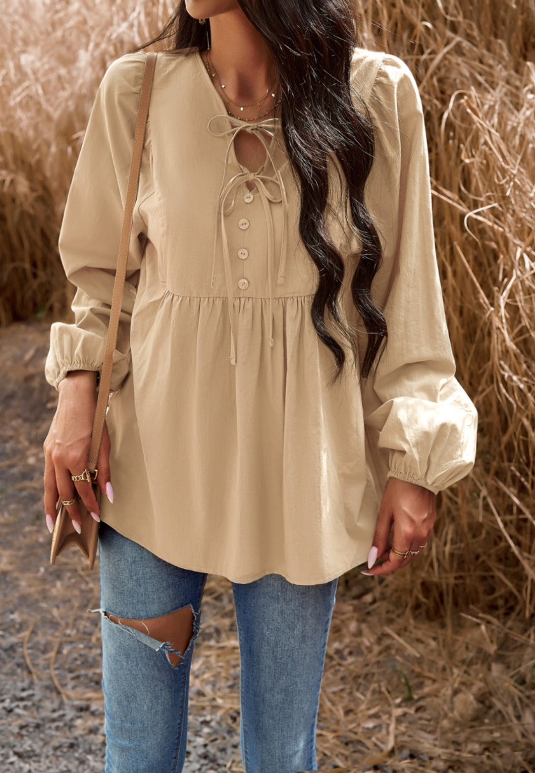 Blusa con botones y cuello con lazo doble