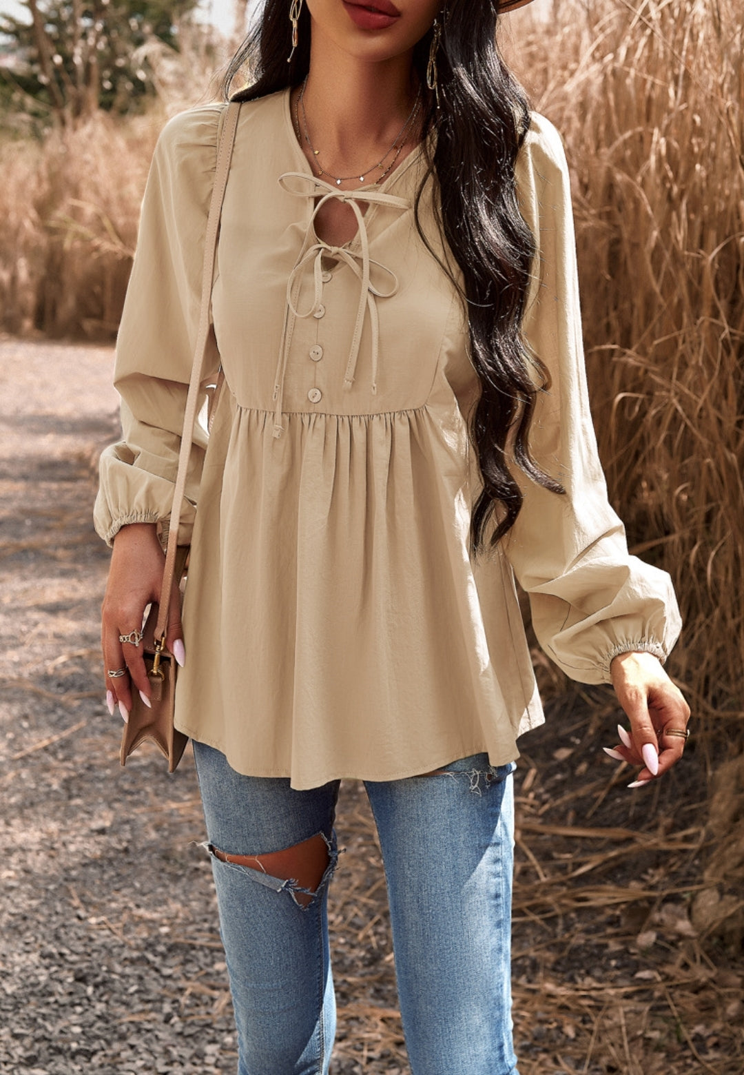 Blusa con botones y cuello con lazo doble
