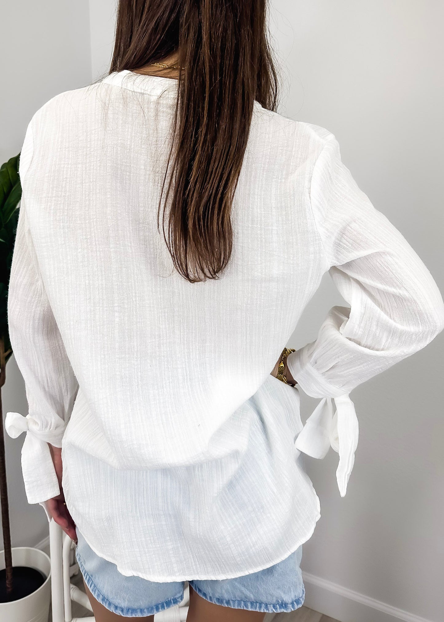 Blusa plisada con mangas abiertas