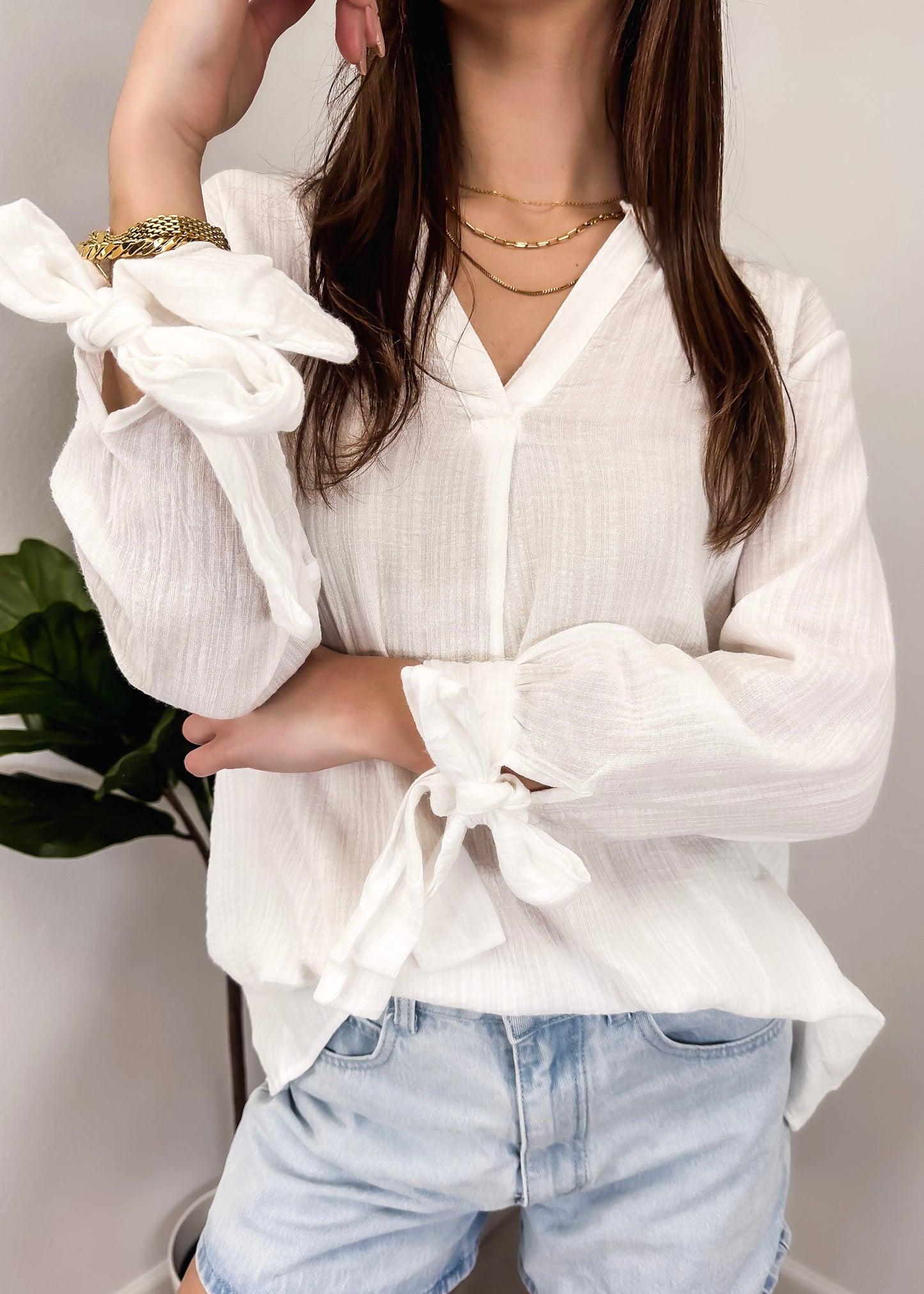 Blusa plisada con mangas abiertas
